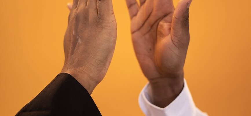 hands of black people in black and white shirts